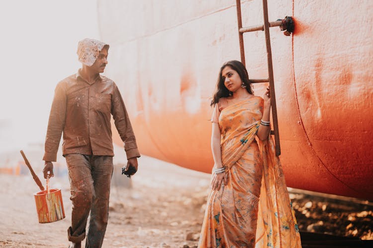 A Physical Worker Passing A Girl In Sari 