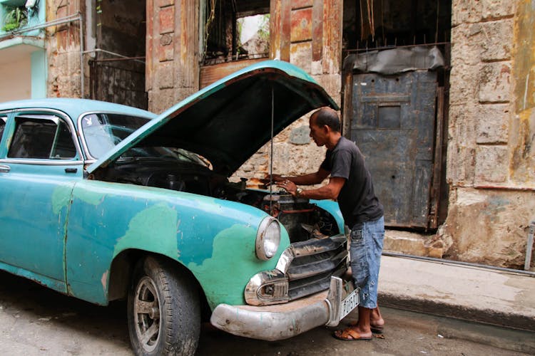 Man Fixing The Engine Of A Car