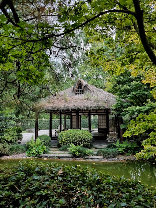 Gazebo with a Thatched Roof in a Park 