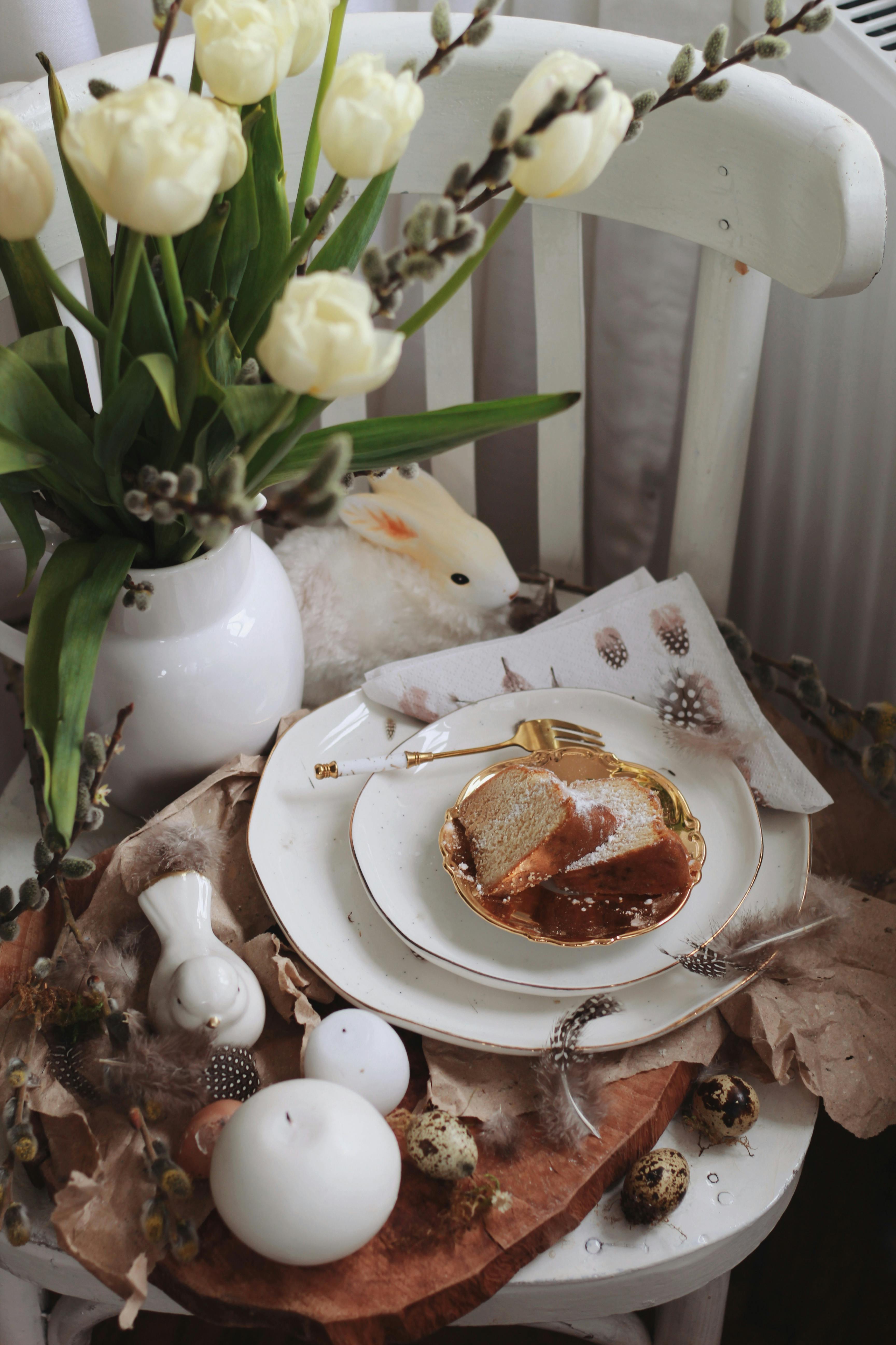 Charming rustic table setting with fresh tulips, bread, and quail eggs, conveying spring elegance.