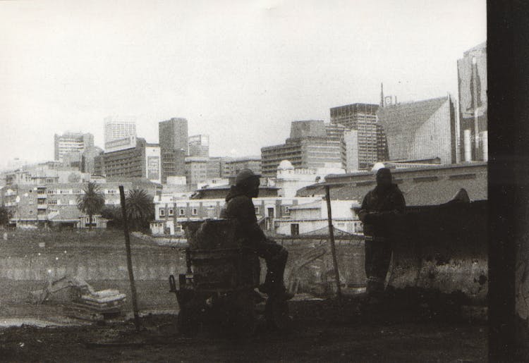 
A Grayscale Of Construction Workers Taking A Break