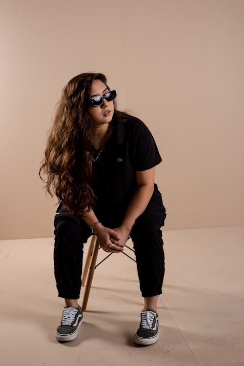 

A Woman Wearing a Black Outfit and Sunglasses