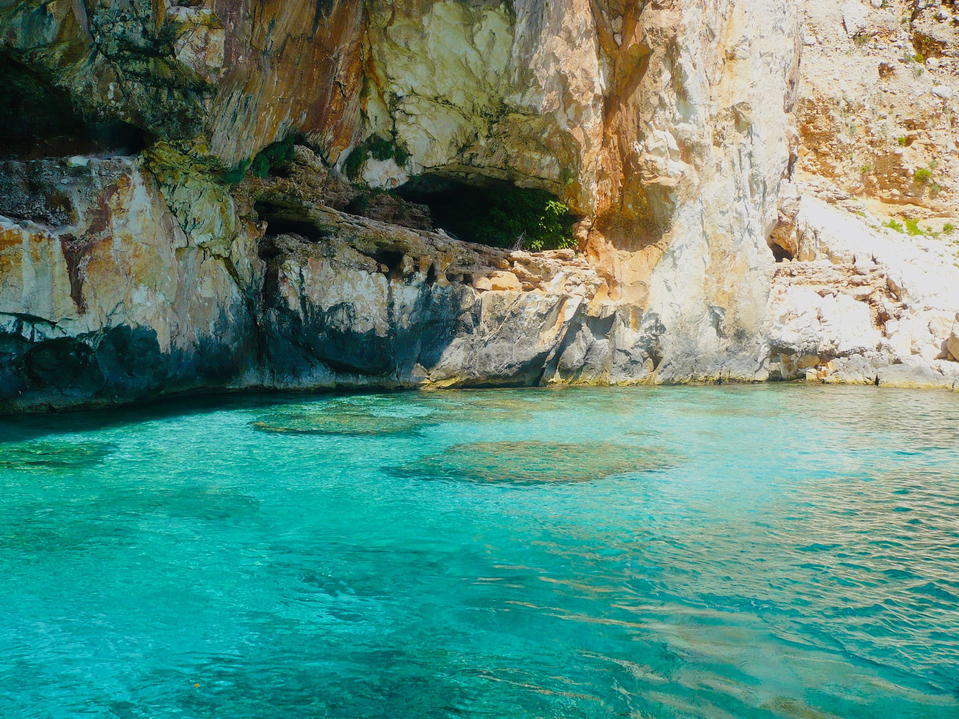 Explore the vibrant turquoise waters and rocky cliffs of Baunei, Italy. Perfect for travel enthusiasts. - Photo by Martina Amaro on Pexels