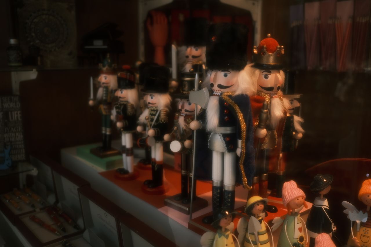 a collection of nutcracker figurines brightly displayed in a store win