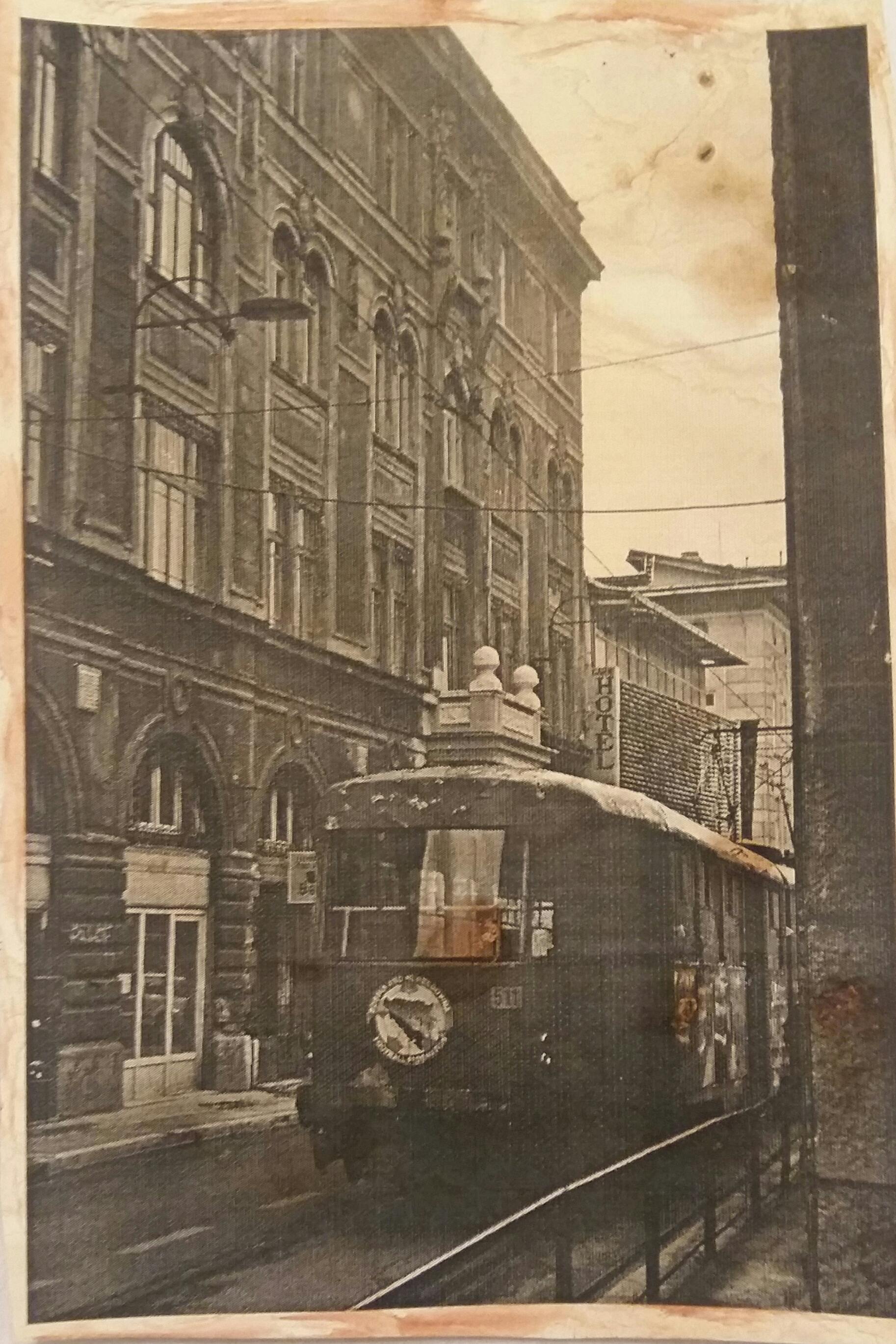 A vintage streetcar on a historic street with classic architecture.