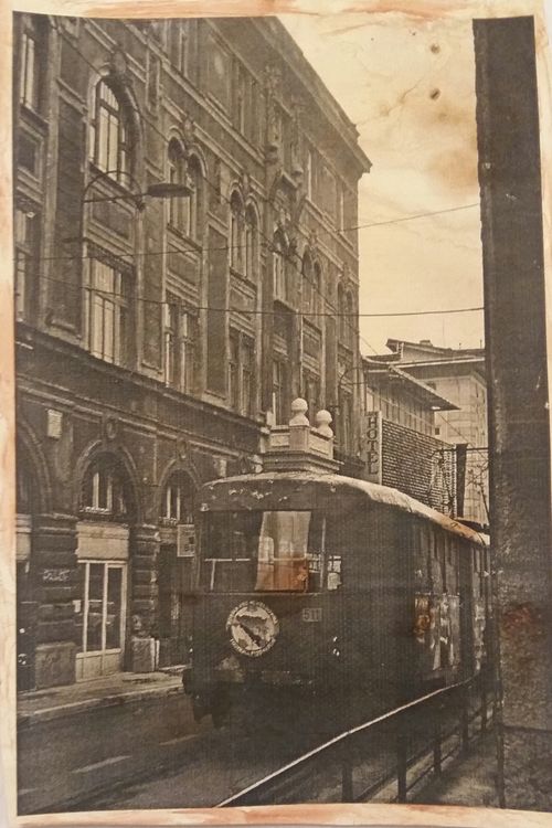 Free A vintage streetcar on a historic street with classic architecture. Stock Photo