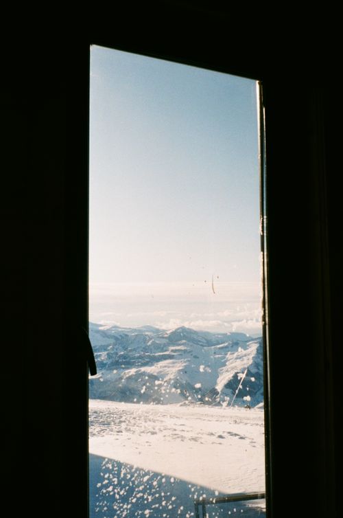 Free View of snow-covered mountains through a window, captured in Gudauri, Georgia. Stock Photo