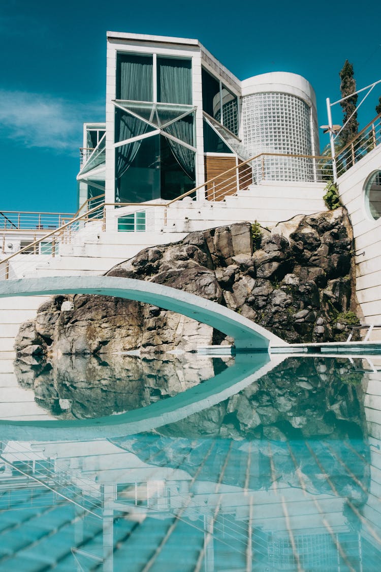 Bridge Over Pool And Staircase In Front Of Hotel Building