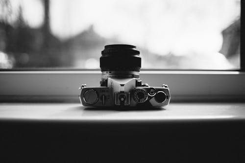 Grayscale Photo of Gray Mirrorless Camera