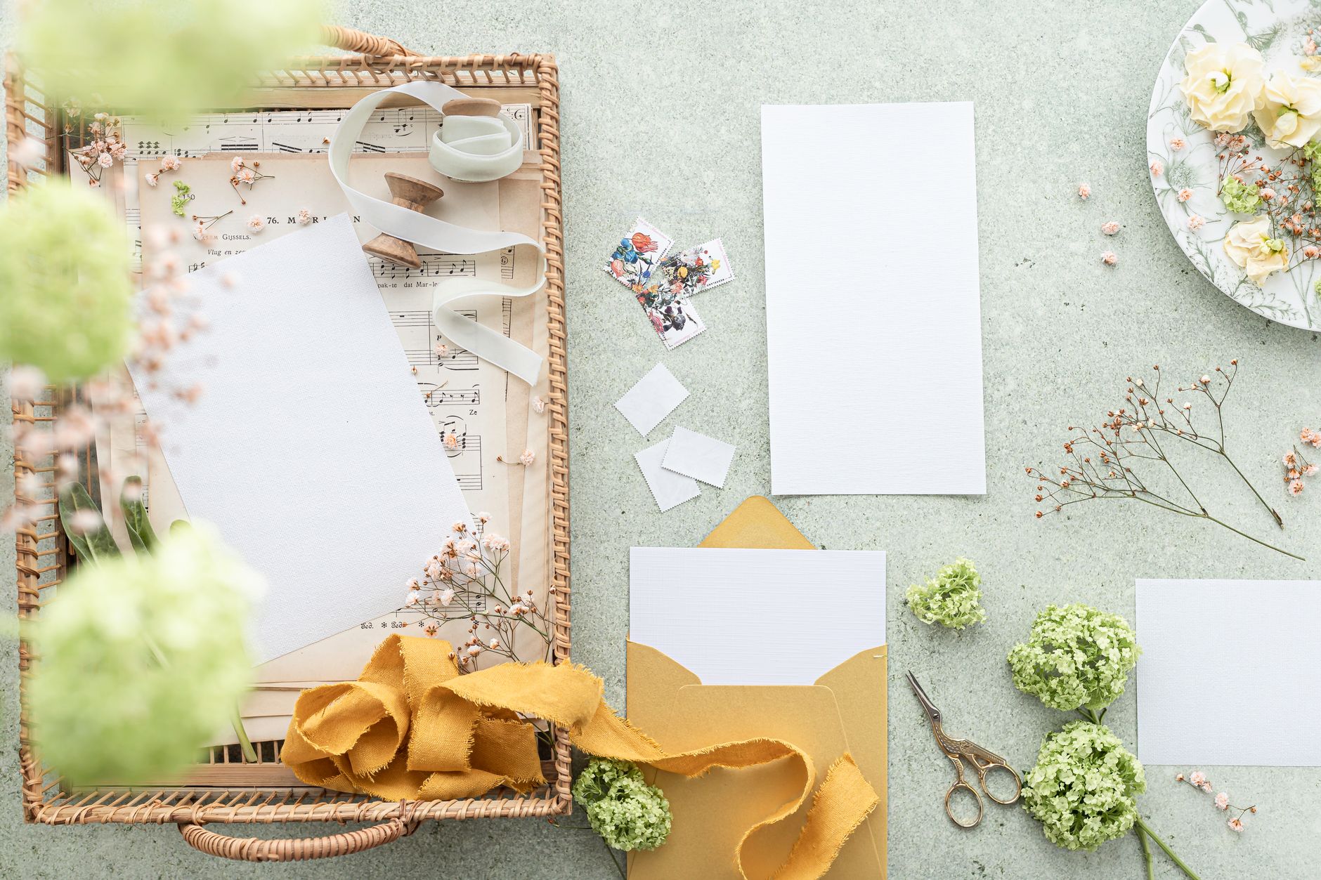 Charming flat lay of floral stationery with vintage elements, perfect for creative projects and weddings.