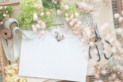 White Paper on the Music Sheets Surrounded with Flowers