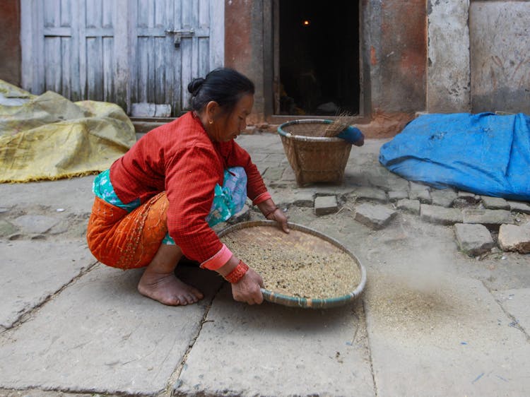 Woman Crouching With Tray