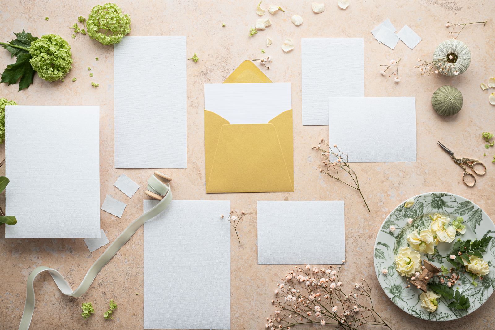 Blank stationery and envelopes with simple floral details.