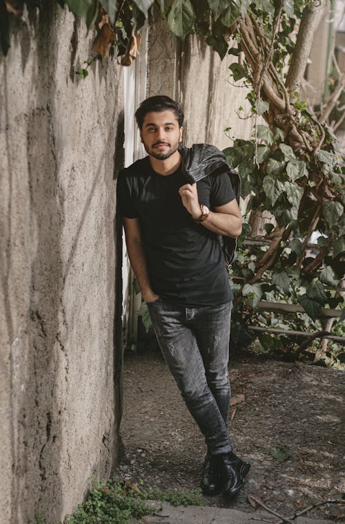 Man Posing near Tree and Wall