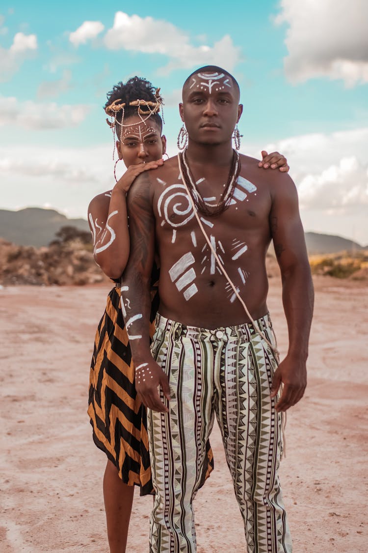 Woman Standing Behind A Man With Her Hands On His Shoulders