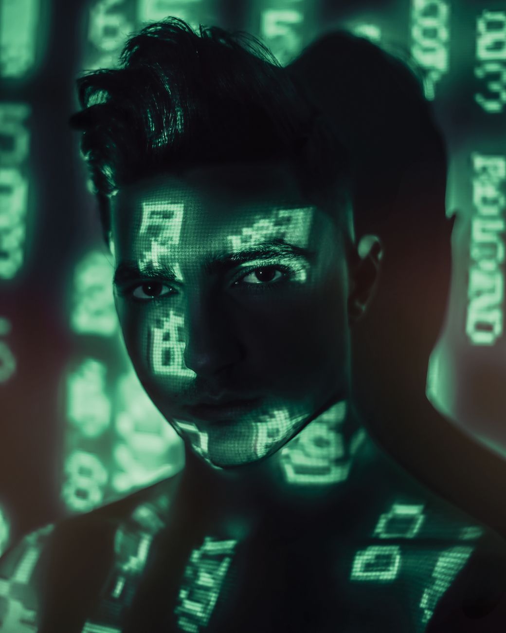 A man with digital numbers projected onto his face, creating a tech-inspired portrait.