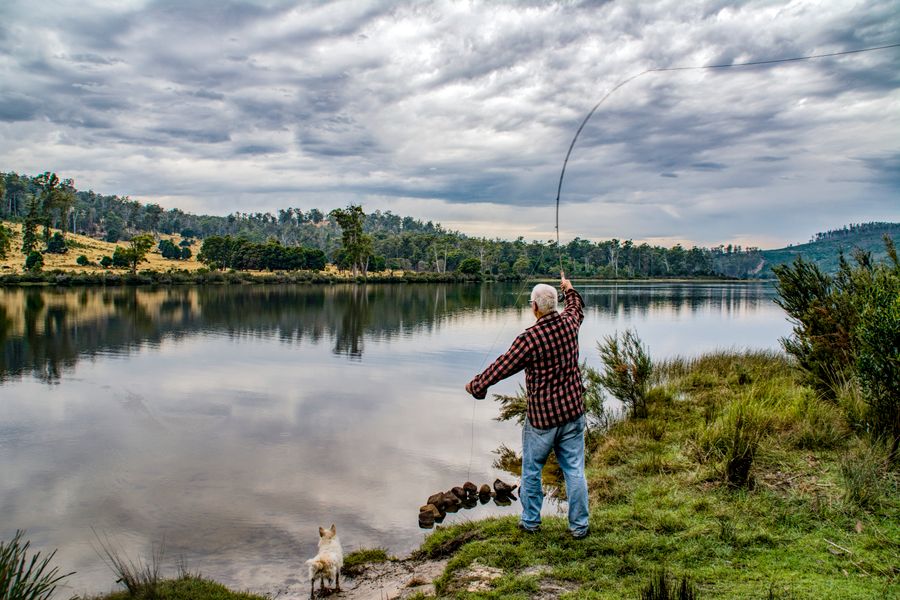 Woman fishing with a rod at the lake