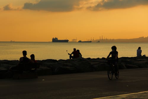 Sea and People on Coastline at Dawn