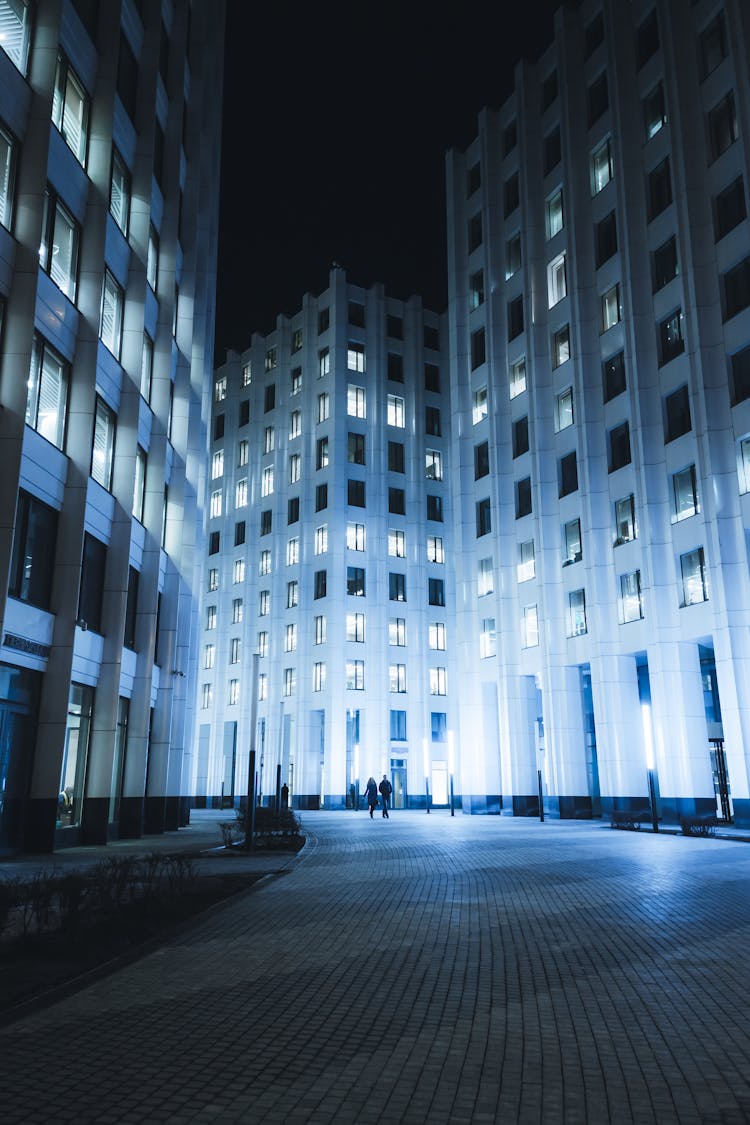 Night View Of Illuminated City Street And Buildings In Residential Area