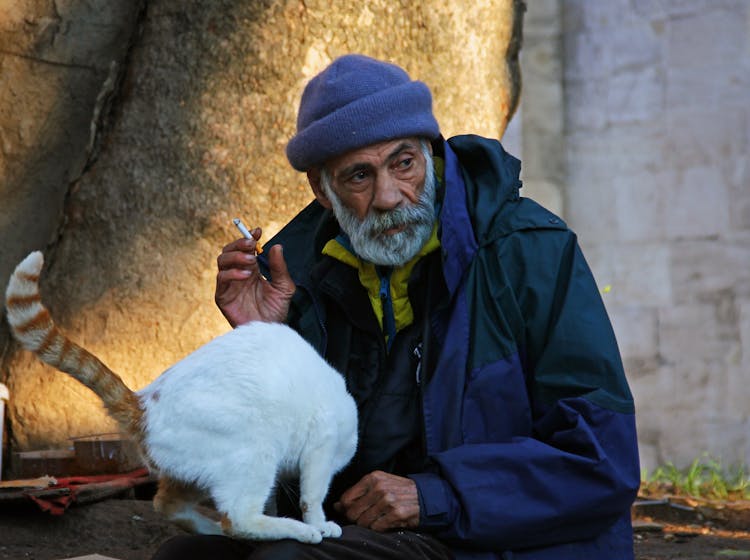 Man Smoking Cigarette With Cat