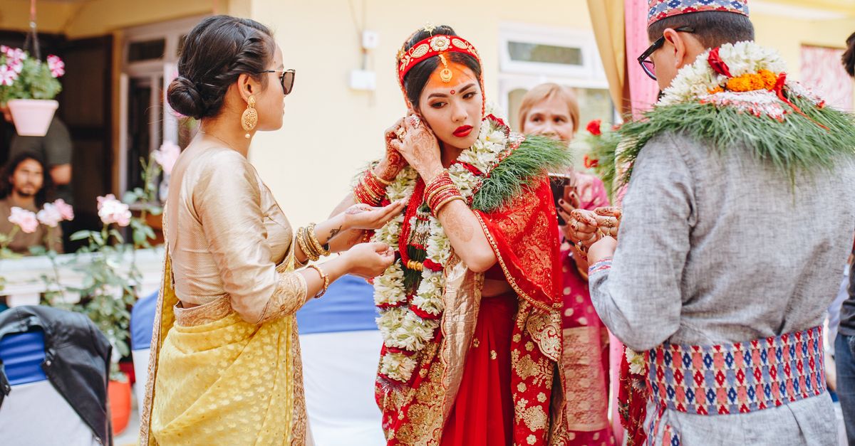 A vibrant scene of a traditional Nepali wedding with cultural attire and garlands.