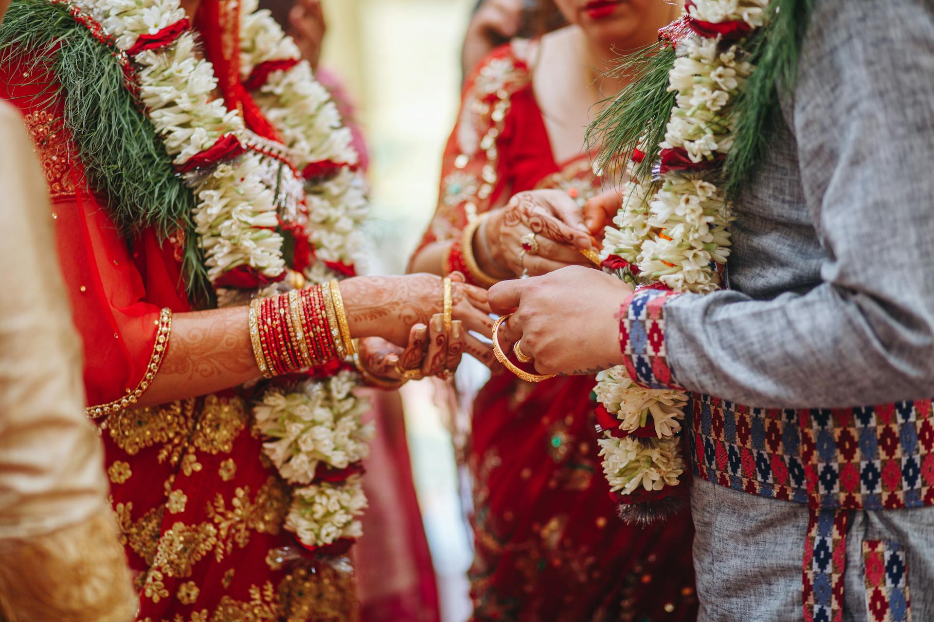 Close Up on Hands of Man and Woman during a Traditional Wedding Ceremony