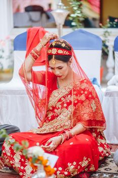 Beautiful Indian bride in red saree during traditional wedding ceremony.