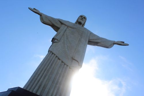 Free Iconic Christ the Redeemer statue in Rio de Janeiro under a bright blue sky. Stock Photo