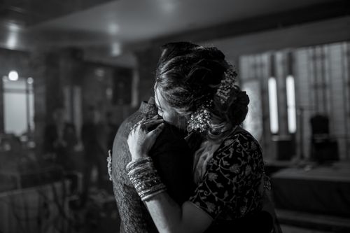 Free A couple embraces while slow dancing in an elegant setting. Stock Photo