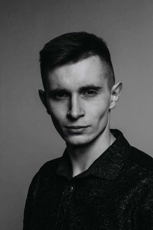 Free Stylish black and white studio portrait of a young caucasian man in a contemplative pose. Stock Photo