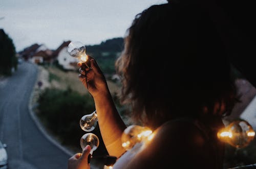 Woman Holding a String Lights