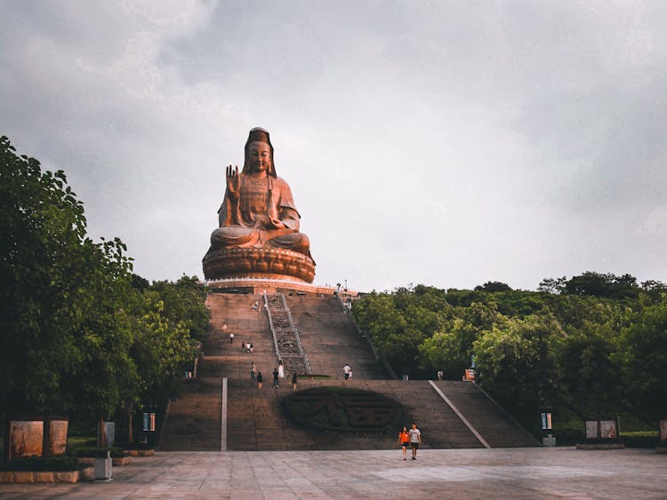 Guanyin Statue Under A Cloudy Sky