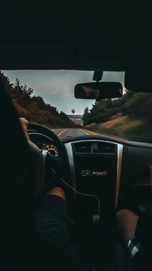 Free A Person Driving a Car on the Road Stock Photo