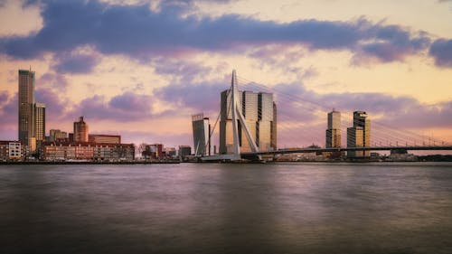 Cityskyline near a Suspension Bridge during Dusk 