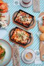 Casseroles in Pot, Coffee Cups and Plates with Side Dishes