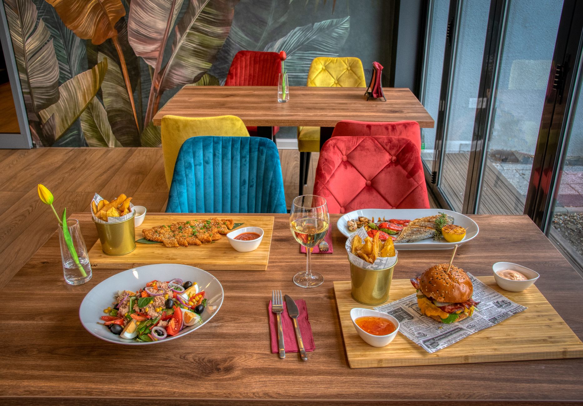 Colorful dining setup in a restaurant with several meals