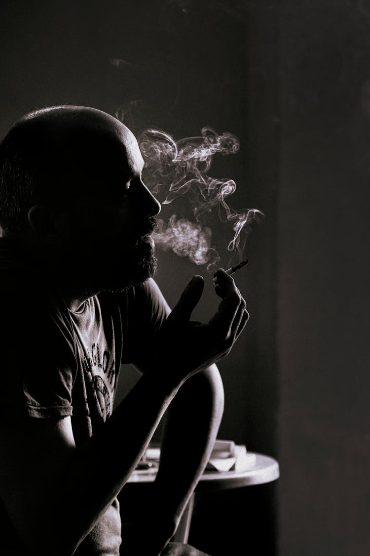 Grayscale Photo Of A Man Smoking 