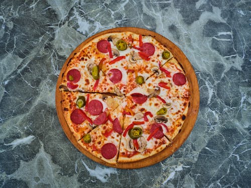Overhead Shot of Pizza on a Marble Surface