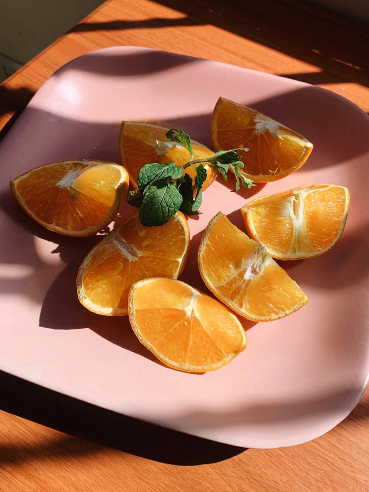 Close-up Of Orange Wedges On A Plate