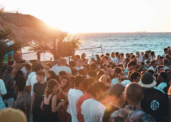 Crowd dancing outdoors at first light — photo by Lloyd James on Pexels