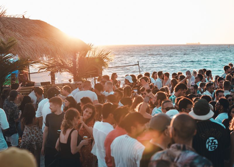 People celebrating on a beach during sunset