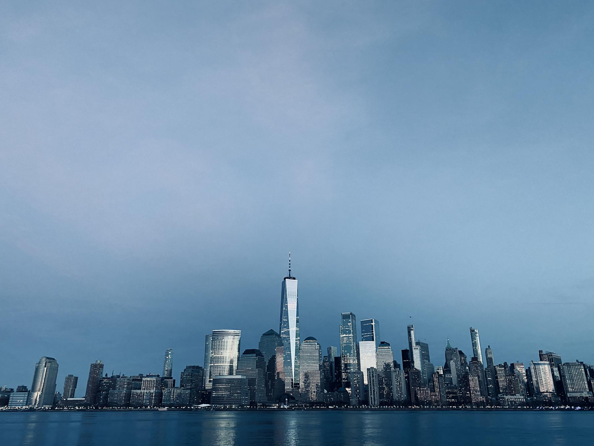 A stunning view of the New York City skyline, including One World Trade Center, from Jersey City.