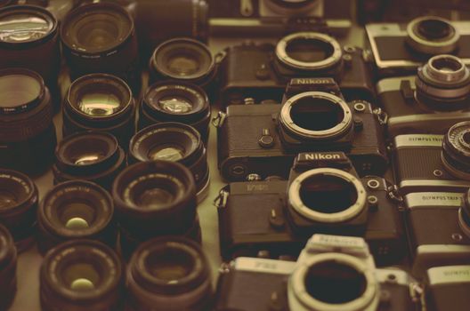 A display of vintage cameras and lenses, showcasing classic photography equipment.