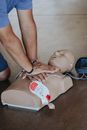 Hands of Person Doing CPR on Training Dummy