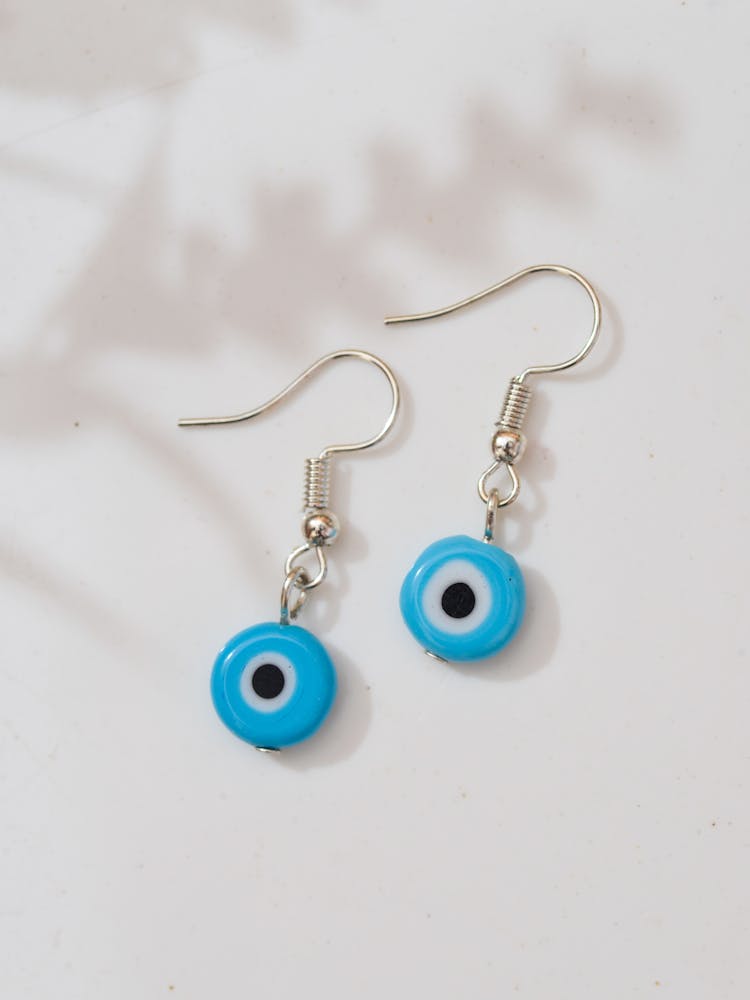 A Pair Of Blue And Silver Round Earrings