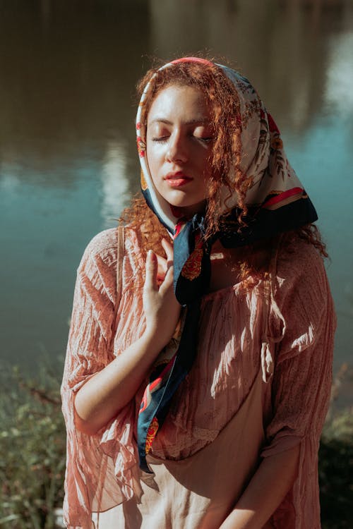 Photo of Redhead Woman with Closed Eyes in Kerchief on Head