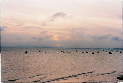 Silhouettes of Boats at Sea