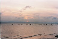 Silhouettes of Boats at Sea