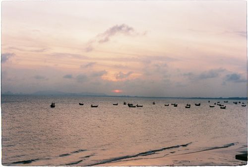 Free Tranquil seascape with boats at sunset in Vũng Tàu, Vietnam. Stock Photo