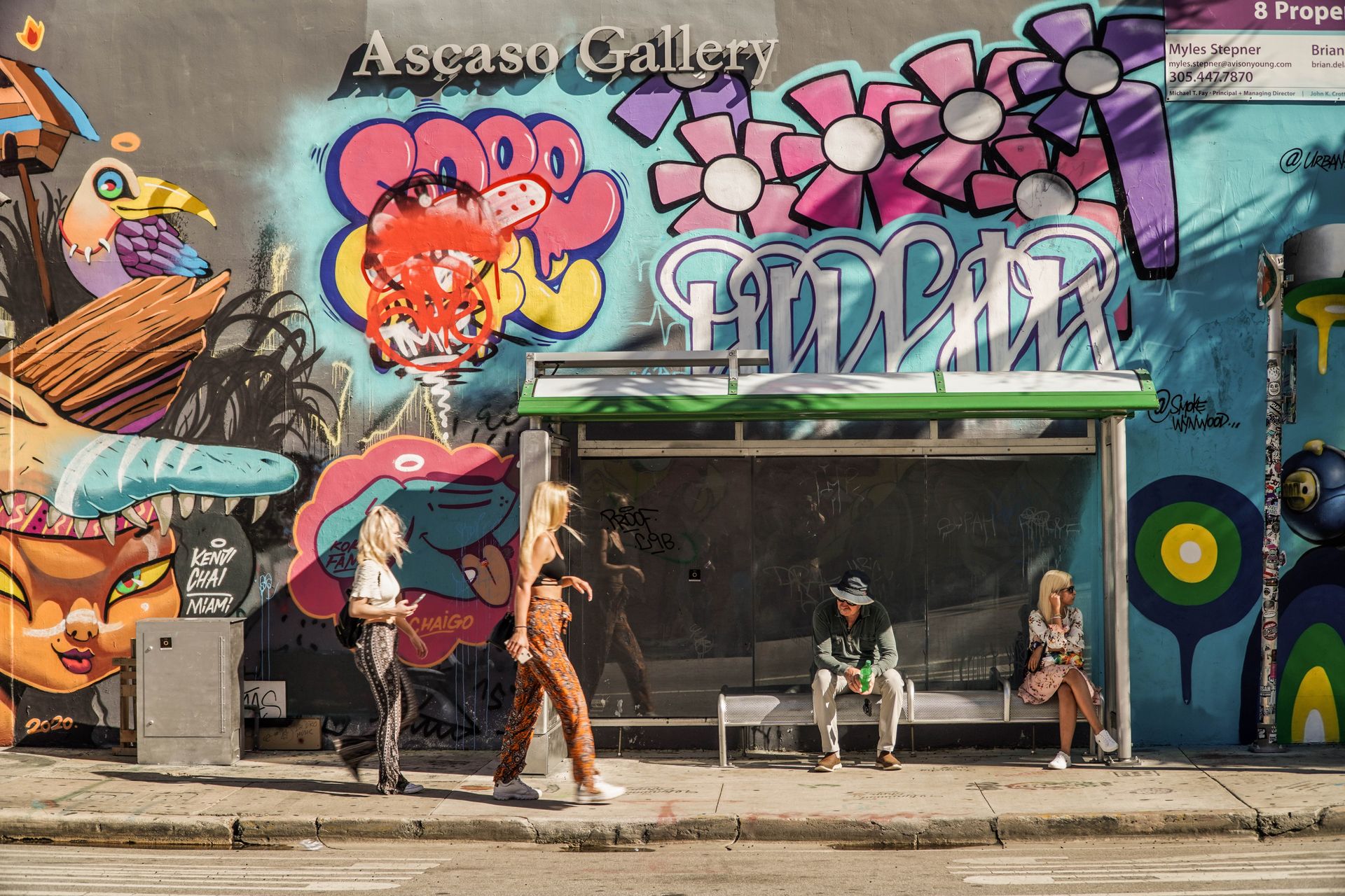 Colorful street art mural in Wynwood Miami with vibrant pink, blue, and yellow graffiti designs on building facade
